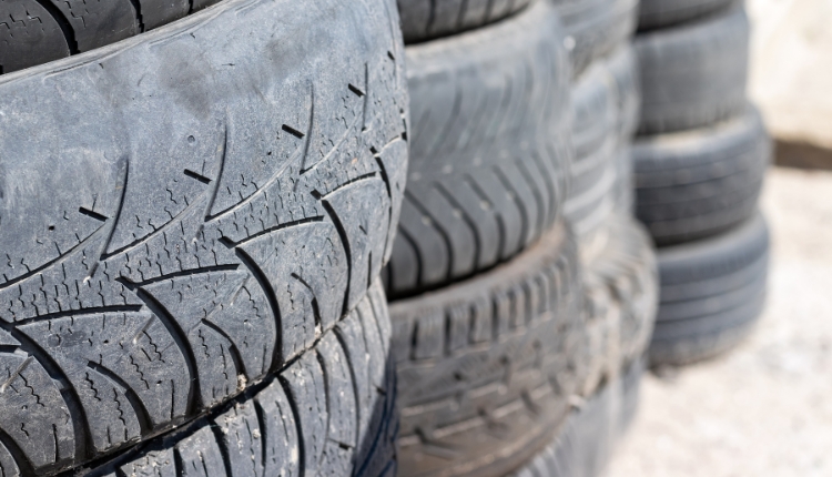 old tires stacked on each other in the sand